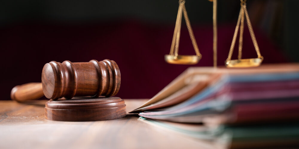 Focus,On,Hammer,,Group,Of,Files,On,Judge,Table,Covered